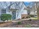 Close-up of the home's entrance featuring a decorative wreath and tidy landscaping at 8636 Robinson Forest Dr, Charlotte, NC 28277