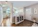 Inviting entryway with hardwood floors, cabinet, and views into the living spaces at 8636 Robinson Forest Dr, Charlotte, NC 28277