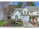 Charming townhome featuring a garage, landscaped front yard, and classic architectural details at 8636 Robinson Forest Dr, Charlotte, NC 28277