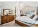 Spacious main bedroom with a four-poster bed, neutral carpet, and a ceiling fan at 8636 Robinson Forest Dr, Charlotte, NC 28277