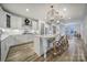 Modern kitchen with white cabinets, a large island, and hardwood floors at 925 Gray Hook Dr, Fort Mill, SC 29708