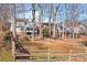 View of house from backyard with split rail fence at 9600 Kayce Ln, Charlotte, NC 28213