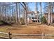 Backyard view of house with wooden fence and trees at 9600 Kayce Ln, Charlotte, NC 28213