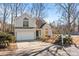 Two-story house with gray siding, a white garage door, and landscaping at 9600 Kayce Ln, Charlotte, NC 28213