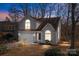 Two-story house with gray siding, a white garage door, and landscaping at 9600 Kayce Ln, Charlotte, NC 28213