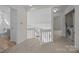 Upstairs hallway with carpet and access to bathroom and laundry at 9600 Kayce Ln, Charlotte, NC 28213