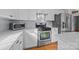 White kitchen with stainless steel appliances and an island at 9600 Kayce Ln, Charlotte, NC 28213