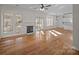 Bright living room with hardwood floors, fireplace, and access to sunroom at 9600 Kayce Ln, Charlotte, NC 28213