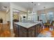 Large kitchen island with granite top, dark cabinetry, and double sinks at 10715 Campbell Commons Way, Charlotte, NC 28277