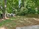 Large backyard with grassy area, storage shed, and wooden fence at 1317 Downs Ave, Charlotte, NC 28205