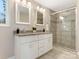 Updated bathroom features double sinks, granite countertops, and a walk-in shower at 1317 Downs Ave, Charlotte, NC 28205