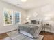 Cozy bedroom with hardwood floors, a comfortable bed, and plenty of natural light at 1317 Downs Ave, Charlotte, NC 28205