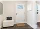 Bright entryway with tile flooring, a bench, and a white door at 1317 Downs Ave, Charlotte, NC 28205