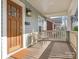 Inviting front porch with wood flooring and charming seating area at 1317 Downs Ave, Charlotte, NC 28205