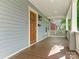 Inviting front porch with wooden flooring and a wooden door at 1317 Downs Ave, Charlotte, NC 28205