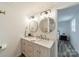 Bright bathroom with double sink vanity and gold accents with wood grain flooring at 1410 Mays Chapel Church Rd, Newton, NC 28658