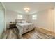 Cozy bedroom with neutral decor, wood-look floors, and plenty of natural light at 1410 Mays Chapel Church Rd, Newton, NC 28658