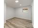 A bedroom featuring wood-look floors, white walls, and an updated window at 1410 Mays Chapel Church Rd, Newton, NC 28658