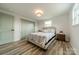 Comfortable bedroom featuring a stylish bed frame, wood-look floors, and double closets at 1410 Mays Chapel Church Rd, Newton, NC 28658