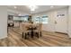 Bright dining area showcases laminate floors and a modern kitchen, perfect for entertaining at 1410 Mays Chapel Church Rd, Newton, NC 28658