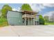 Large home with an upper-level balcony, gray siding and parking area at 1410 Mays Chapel Church Rd, Newton, NC 28658