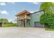 Green home with a covered balcony and an attached garage on a grassy lot at 1410 Mays Chapel Church Rd, Newton, NC 28658