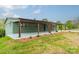 One-story brick house boasts a covered front porch with wooden posts, complemented by well-maintained landscaping at 1410 Mays Chapel Church Rd, Newton, NC 28658