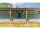 Charming entrance to a brick home, adorned with wooden support beams and fresh landscaping, sets a welcoming tone at 1410 Mays Chapel Church Rd, Newton, NC 28658