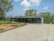 One-story brick home with covered porch, a long driveway, and a lush lawn creates a welcoming curb appeal at 1410 Mays Chapel Church Rd, Newton, NC 28658