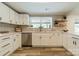 Bright kitchen featuring white cabinetry, stainless steel appliances, and a stylish backsplash at 1410 Mays Chapel Church Rd, Newton, NC 28658