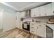 Well-lit kitchen showcases white cabinets, quartz countertops, and modern stainless steel appliances at 1410 Mays Chapel Church Rd, Newton, NC 28658