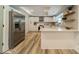 Modern kitchen with stainless steel appliances, white cabinetry, quartz countertops, and laminate floors at 1410 Mays Chapel Church Rd, Newton, NC 28658