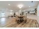 Open-concept living space featuring sleek laminate floors, recessed lighting, dining area and modern kitchen at 1410 Mays Chapel Church Rd, Newton, NC 28658