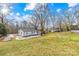 View of the backyard, showing a shed and a mostly flat grassy area at 1449 Cherryville Rd, Shelby, NC 28150