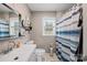 Clean bathroom with white vanity, shower/tub combo, and blue striped curtain at 1449 Cherryville Rd, Shelby, NC 28150