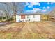 White single story home with gravel driveway and mature trees at 1449 Cherryville Rd, Shelby, NC 28150