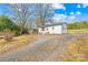Front view of a white single story home with a gravel driveway at 1449 Cherryville Rd, Shelby, NC 28150