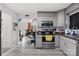 Gray kitchen cabinets, stainless steel appliances, and a view into the living room at 1449 Cherryville Rd, Shelby, NC 28150