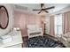 Bedroom with crib, changing table, and pink accent wall at 148 Tarrington Dr, Statesville, NC 28625