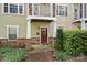 Tan house exterior with brown door, small porch, and manicured landscaping at 1733-C Matheson Ave, Charlotte, NC 28205
