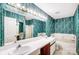 Bathroom with double vanity, bathtub, and teal wallpaper at 1749 Ridgefield Ct, Rock Hill, SC 29732