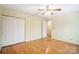 Bedroom with hardwood floors, double doors, and ceiling fan at 1749 Ridgefield Ct, Rock Hill, SC 29732