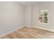 Bedroom with wood-look flooring and a window providing natural light at 1909 Toddville Rd, Charlotte, NC 28214