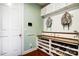 Mudroom features built-in bench seating, shoe storage, hanging hooks, and overhead cabinets for easy organization at 2214 Brandybuck Ct, Fort Mill, SC 29715