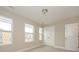 Bright bedroom featuring neutral walls, carpet, and three windows with exterior views and white trim at 2812 Ensemble Ct, Charlotte, NC 28262