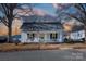 Charming white house with a porch, well-maintained lawn, and mature trees at 298 Misenheimer Nw Dr, Concord, NC 28025