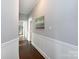 Long hallway with wood floors and wainscoting at 298 Misenheimer Nw Dr, Concord, NC 28025