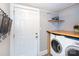 Laundry room with washer, dryer and built in shelving at 298 Misenheimer Nw Dr, Concord, NC 28025