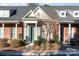 Brick front exterior of townhome with gray accents and landscaping at 3549 Creeping Flora Ln, Charlotte, NC 28216