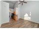 Living room with vaulted ceiling, wood floors, and kitchen with island at 3549 Creeping Flora Ln, Charlotte, NC 28216